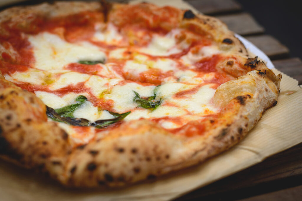 Traditional Neapolitan Margherita pizza with blistered crust and fresh basil