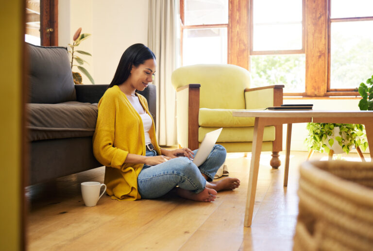Person researching cruise options on a laptop at home, symbolizing how travelers determine the best time to book a cruise for lower fares.