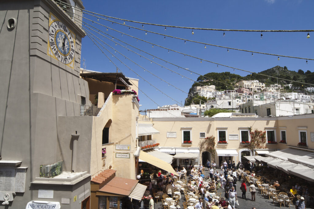 Capri Town Piazzetta with outdoor cafés and visitors exploring the square