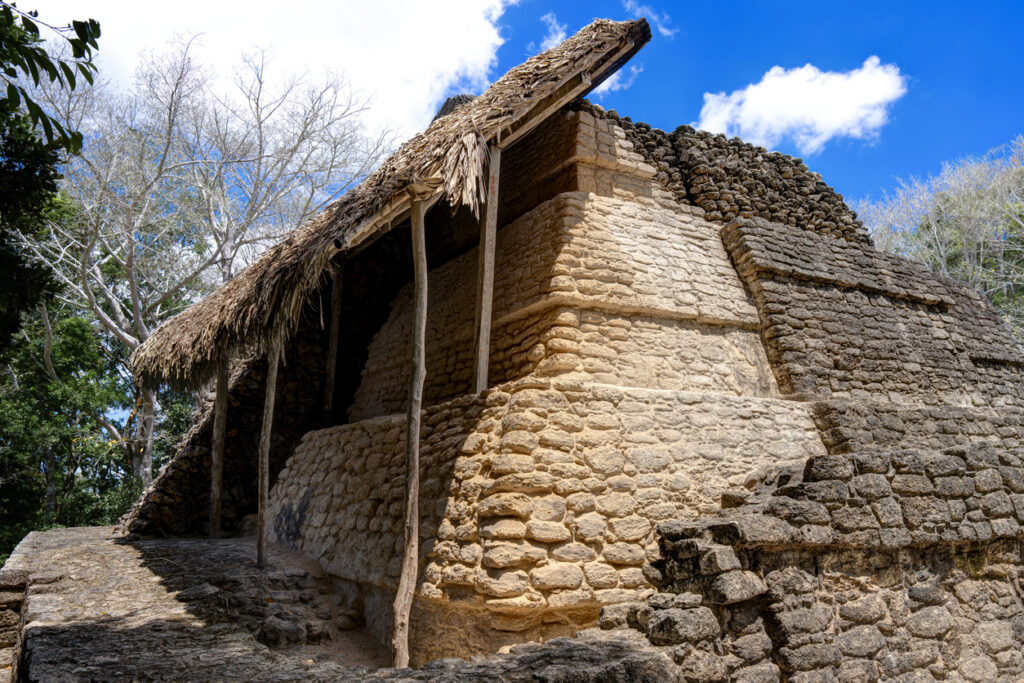Temple 2, the Temple of the Vessels, at Chacchoben Mayan Ruins in Costa Maya, Mexico. This structure dates to around 300–360 AD and features restored stone steps and jungle surroundings.