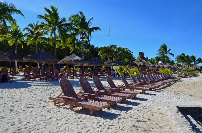 Calm early‑morning beach scene at Chankanaab Beach Adventure Park with gentle waves and a kid‑friendly shoreline.