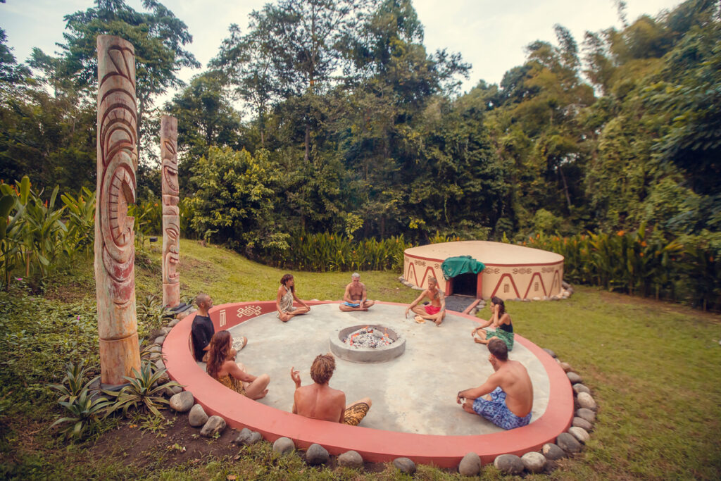 Group preparing for a traditional Mayan Temazcal ceremony in an outdoor ritual space.