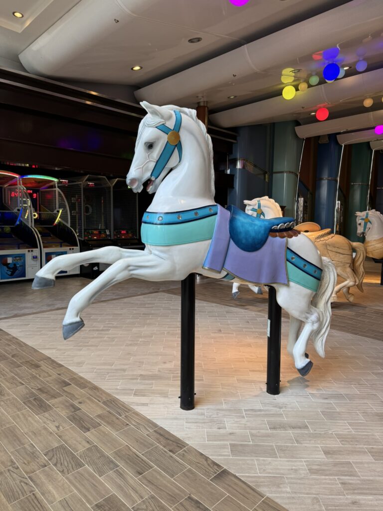Carousel horse on the Royal Caribbean Boardwalk, a fun and iconic spot that works perfectly as a clue location in a cruise ship scavenger hunt.