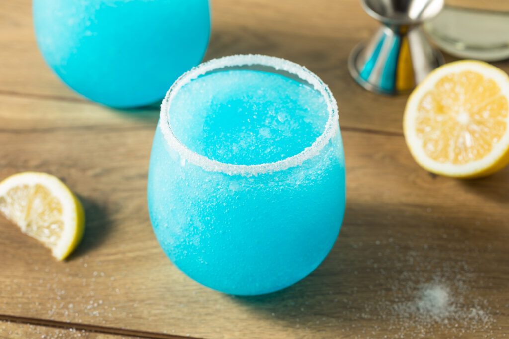 Frozen blue cocktail garnished with lemon, representing the color and flavor of Blue Curaçao liqueur