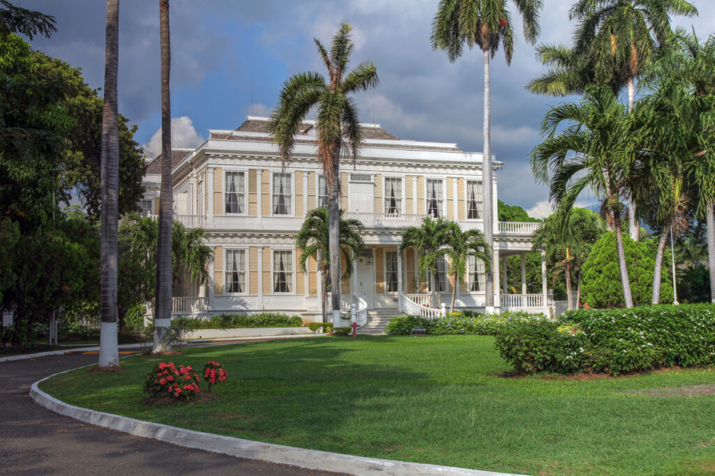 Historic Caribbean-style house with lush gardens, representing the cultural setting of Devon House in Kingston