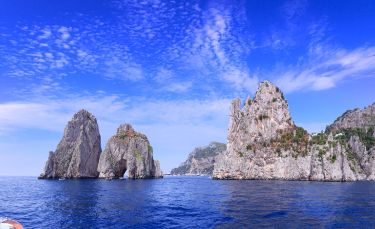 Faraglioni rock formations rising from the turquoise water off the coast of Capri Italy