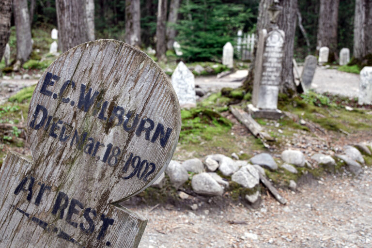 Weathered wooden grave markers in Skagway’s historic Gold Rush Cemetery, the town’s oldest burial ground dating back to the late 1800s.