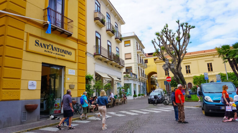 Narrow street in Sorrento’s historic center lined with shops, cafés, and colorful buildings