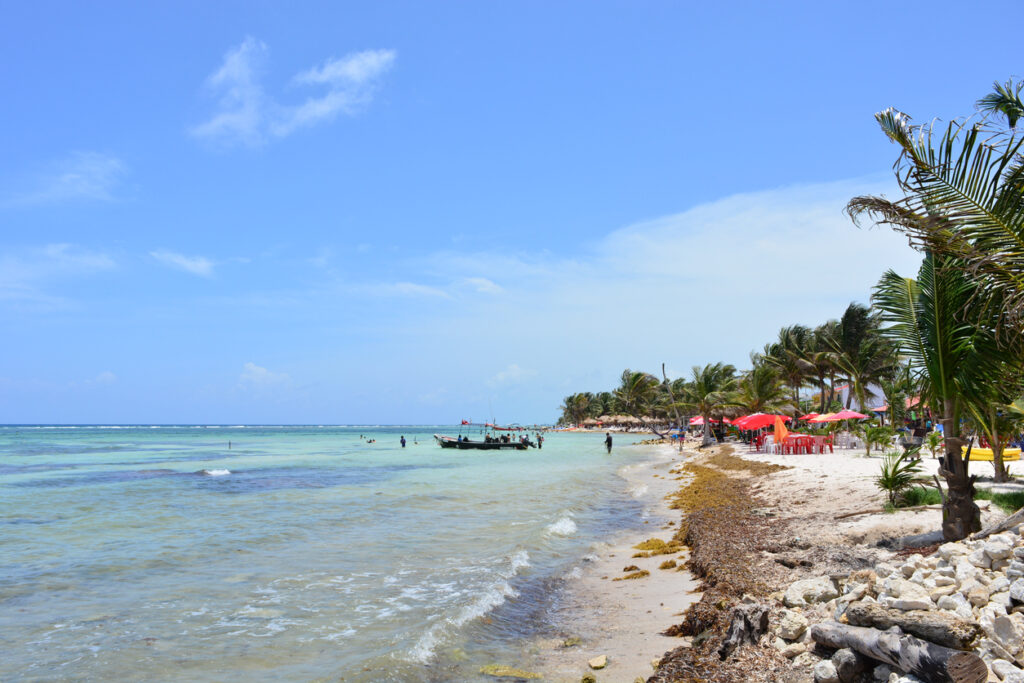 Beachfront scene in the small village of Mahahual, highlighting the relaxed Caribbean coastline along the Malecón in Costa Maya.