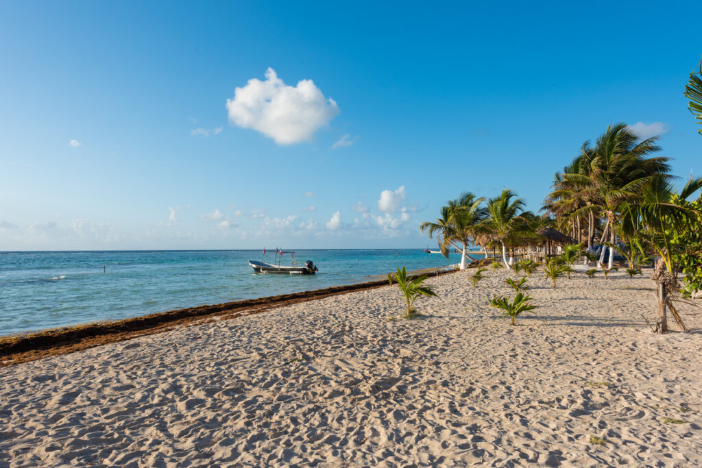 Beachfront in Mahahual, Quintana Roo, showing the calm water and coastal scenery along the Malecón in Costa Maya.