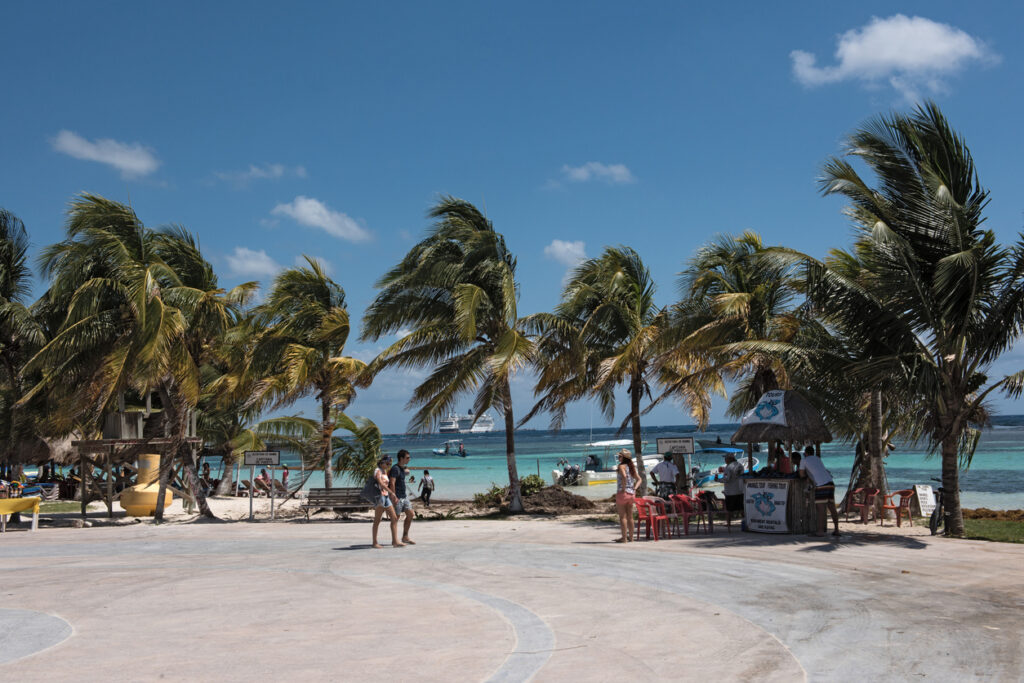 Souvenir shops along the beachfront in Mahahual, showcasing the relaxed, coastal atmosphere of the Malecón in Costa Maya.