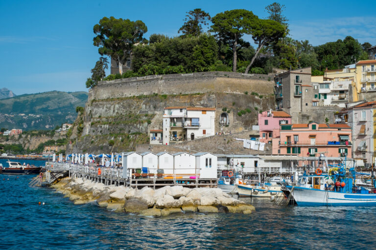 Colorful waterfront houses and fishing boats along Marina Grande in Sorrento