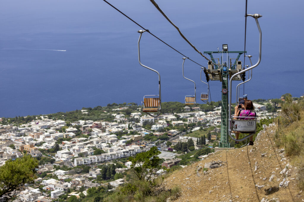 Monte Solaro chairlift ascending above Anacapri with panoramic views of Capri Italy