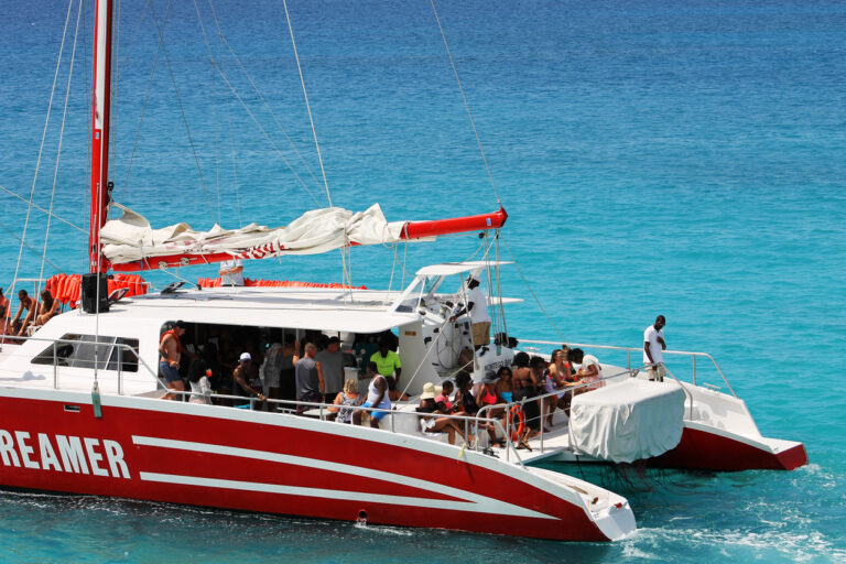 Catamaran sailing along the Montego Bay coastline in Jamaica with clear turquoise water and sunny skies
