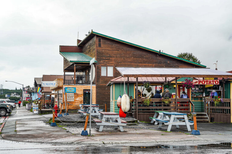 Modern Valdez, Alaska, surrounded by the Chugach Mountains and Prince William Sound on a clear summer day.