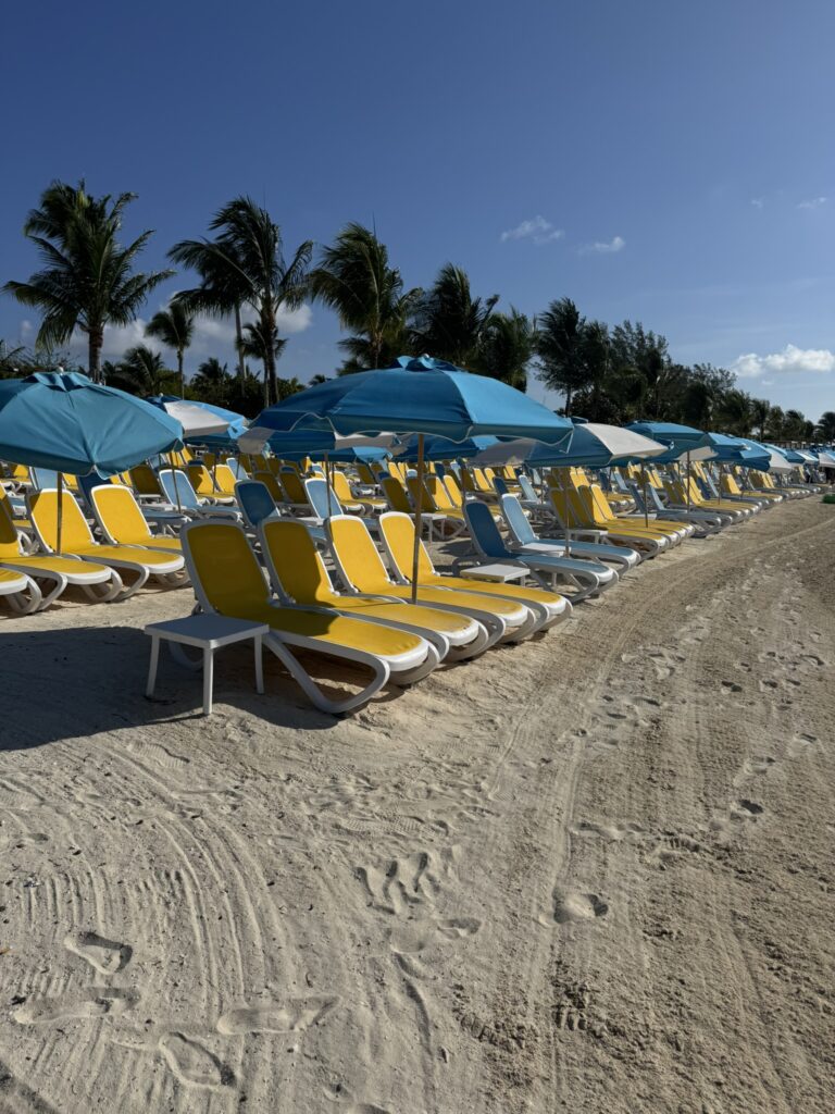 Free beach at Perfect Day at CocoCay with clear water, soft sand, and plenty of open lounge space