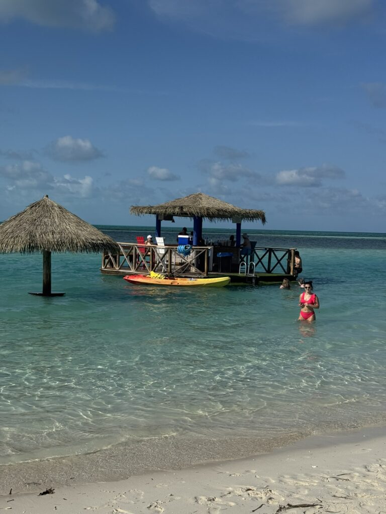 Floating Bar at Perfect Day at CocoCay with guests relaxing in the water near the platform