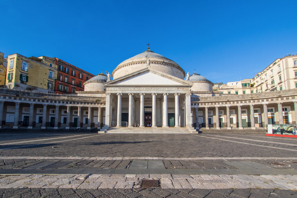 Basilica of San Francesco di Paola in Piazza del Plebiscito, showing its grand neoclassical portico, large central dome, and sweeping semicircular colonnade in Naples, Italy