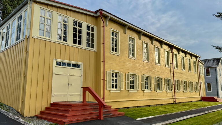 The Russian Bishop’s House in Sitka National Historical Park, a two‑story yellow wooden building with white trim and red front steps, one of the best‑preserved examples of Russian colonial architecture in Alaska.