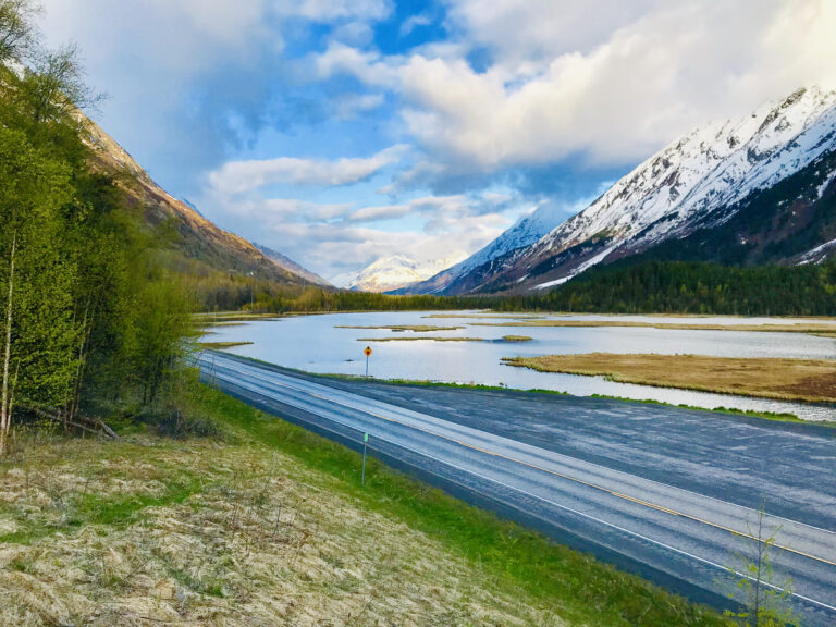 Snowcapped mountains rise above the landscape near Moose Pass on the Kenai Peninsula, a scenic stretch along the Seward Highway in south‑central Alaska.