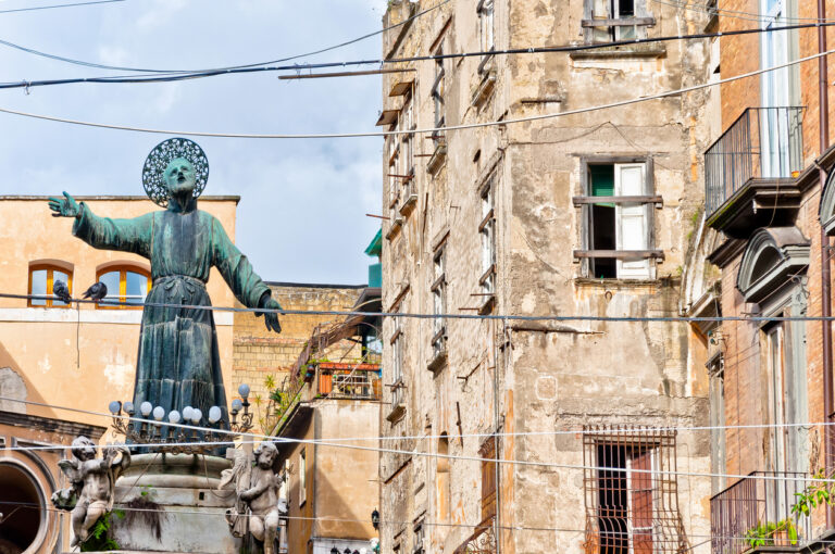 Statue of San Gaetano in Piazza San Gaetano along Spaccanapoli, surrounded by historic Naples buildings with weathered facades