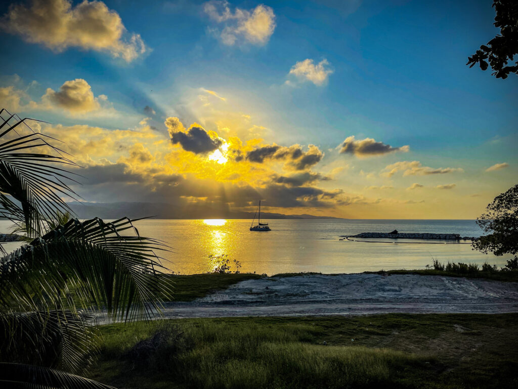 Sunset view over the harbor at Pier One in Montego Bay, Jamaica, with warm colors reflecting on the water