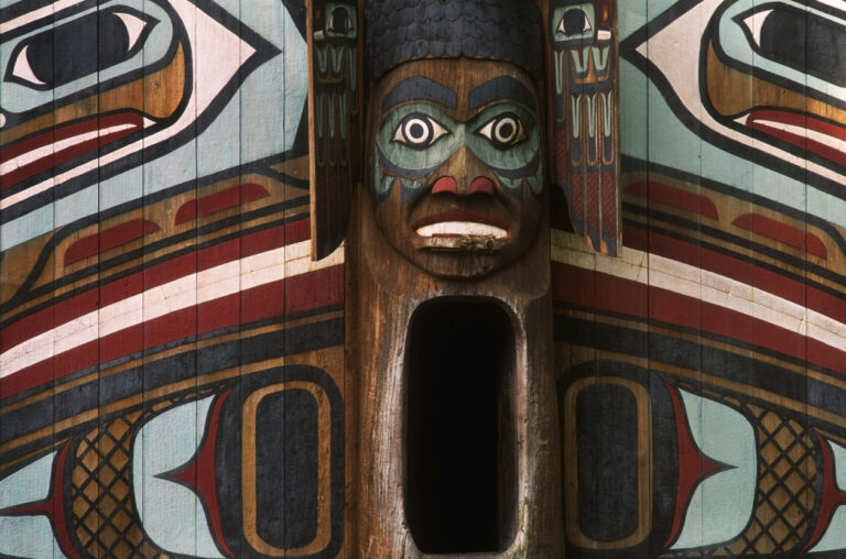 Close‑up of a carved and painted totem pole at Totem Bight State Historical Park in Ketchikan, Alaska.