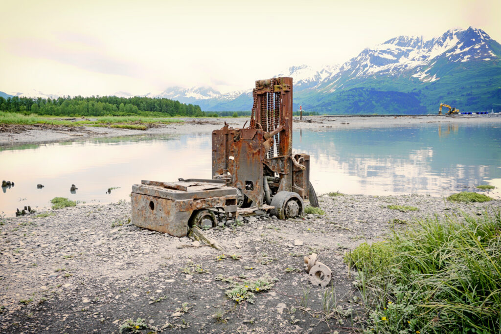 An antique forklift sitting beside the bay in Valdez, Alaska, at the former Old Town site that was destroyed in the 1964 earthquake.