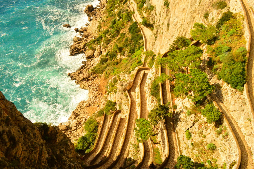 Directly above view of Via Krupp’s winding switchback path on Capri during a sunny day