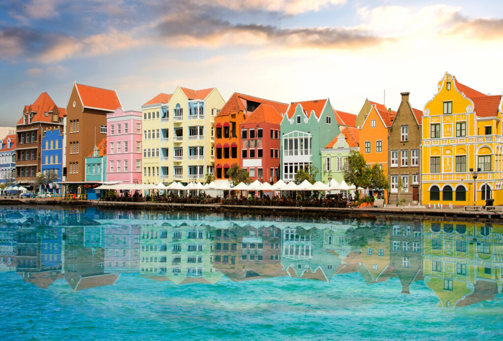 Beautiful sunset sky above the colorful waterfront buildings along the Willemstad embankment in Curaçao